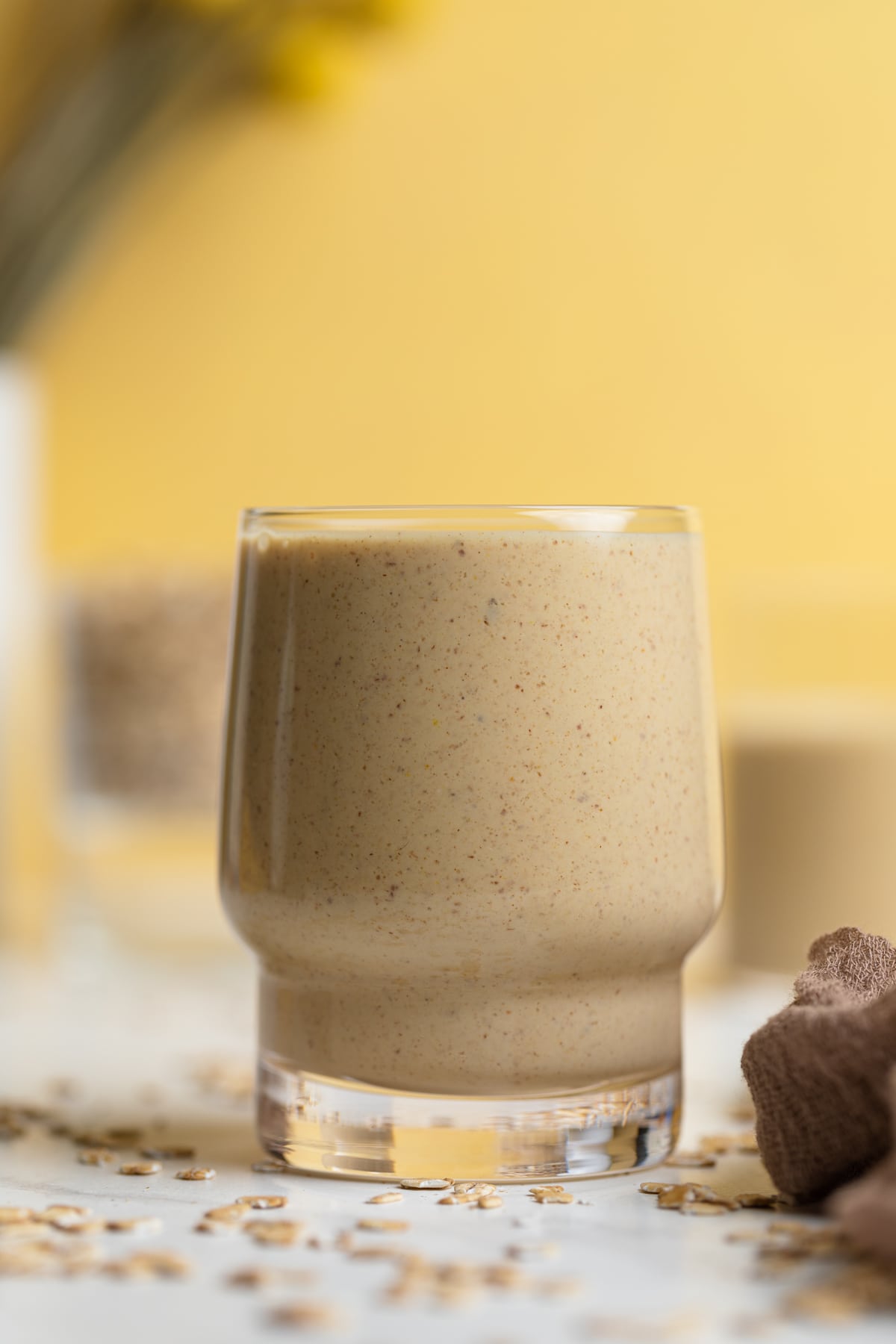 Peanut Butter Banana Oats Smoothie on a table with oats.