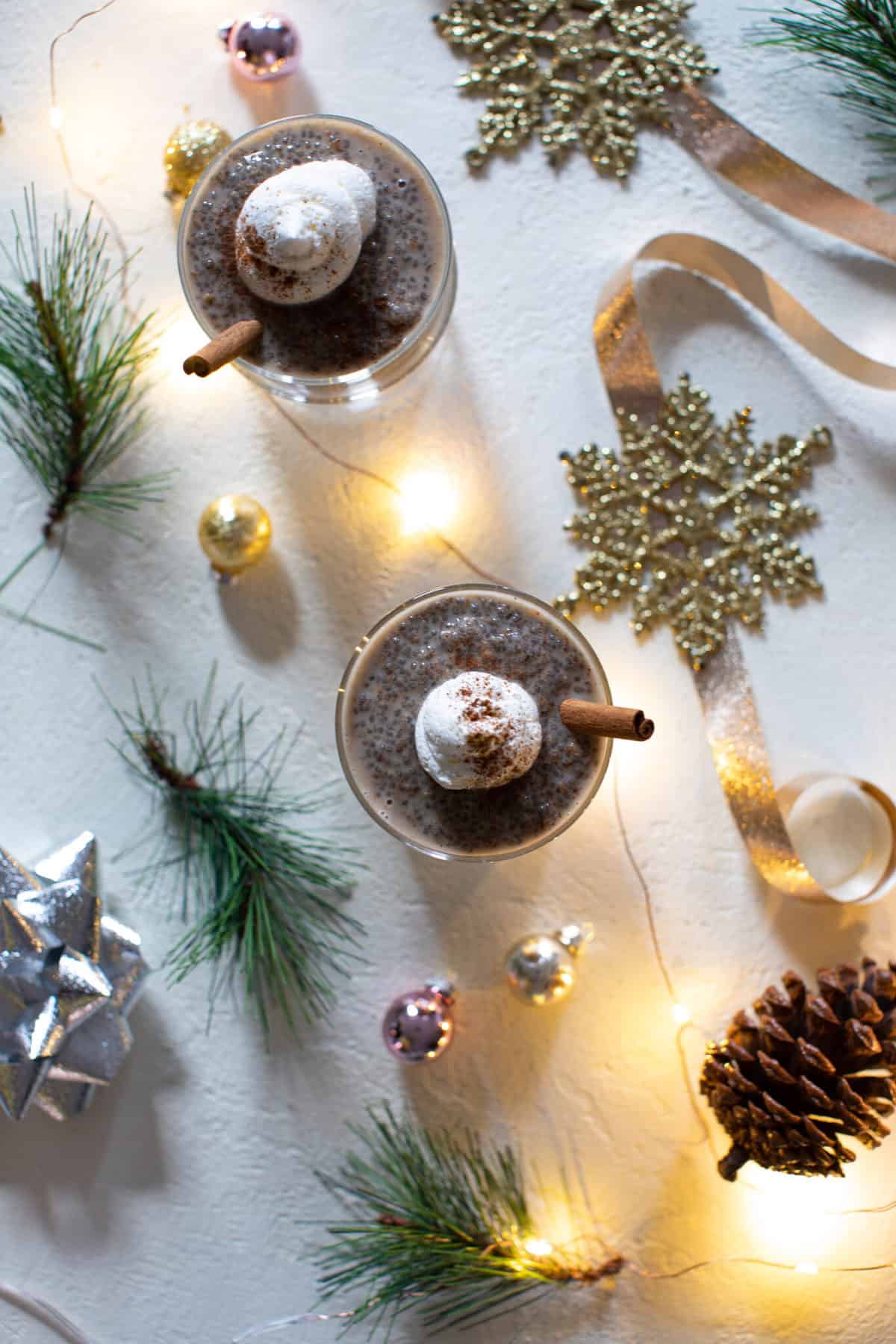 Glass of Chai Latte Chia Pudding on a table with Christmas decorations.