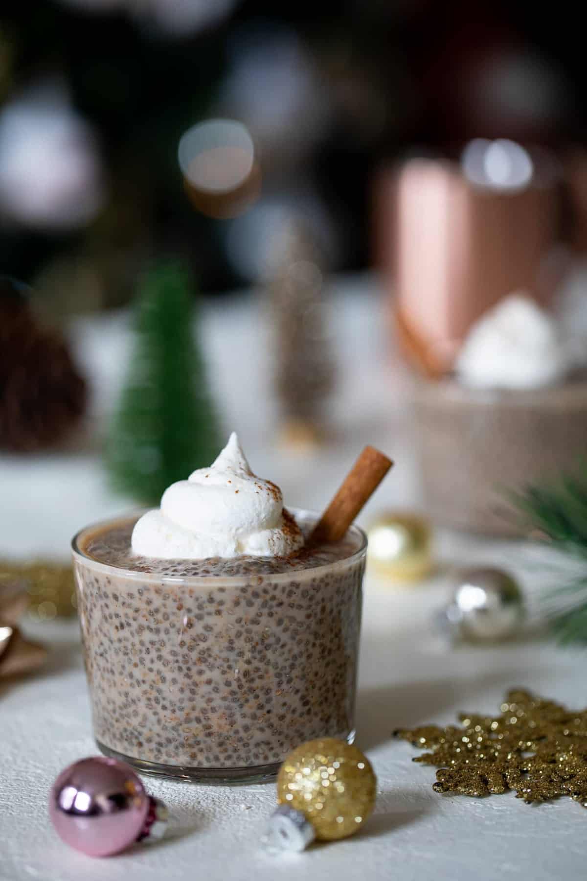 Cinnamon stick in a glass of Chai Latte Chia Pudding.