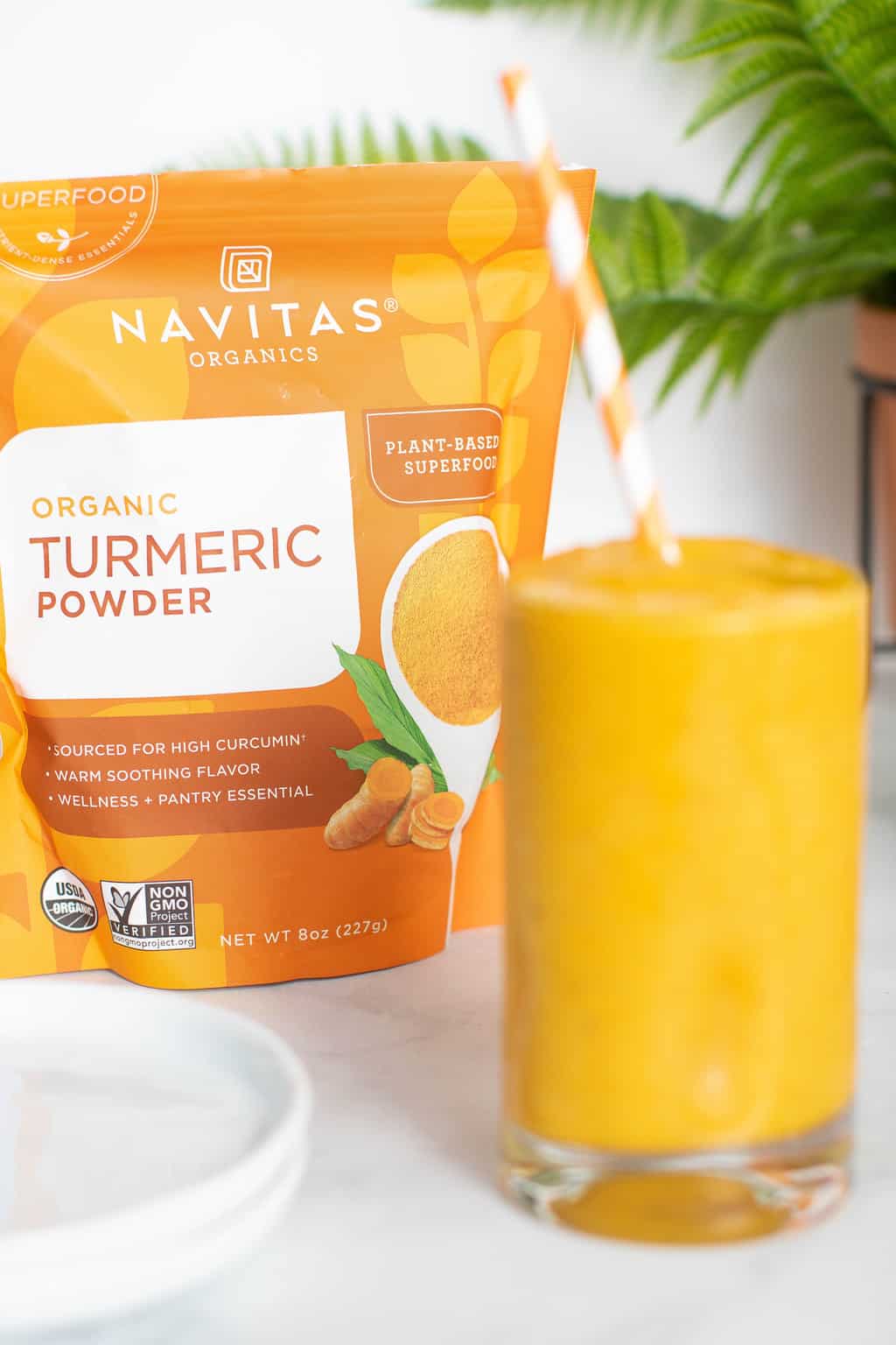 Turmeric \'Wake Up\' Smoothie with a bag of Navitas organic turmeric powder.