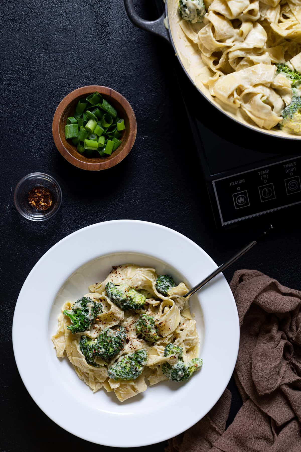 Fork in a plate of Vegan Broccoli Alfredo Pasta.