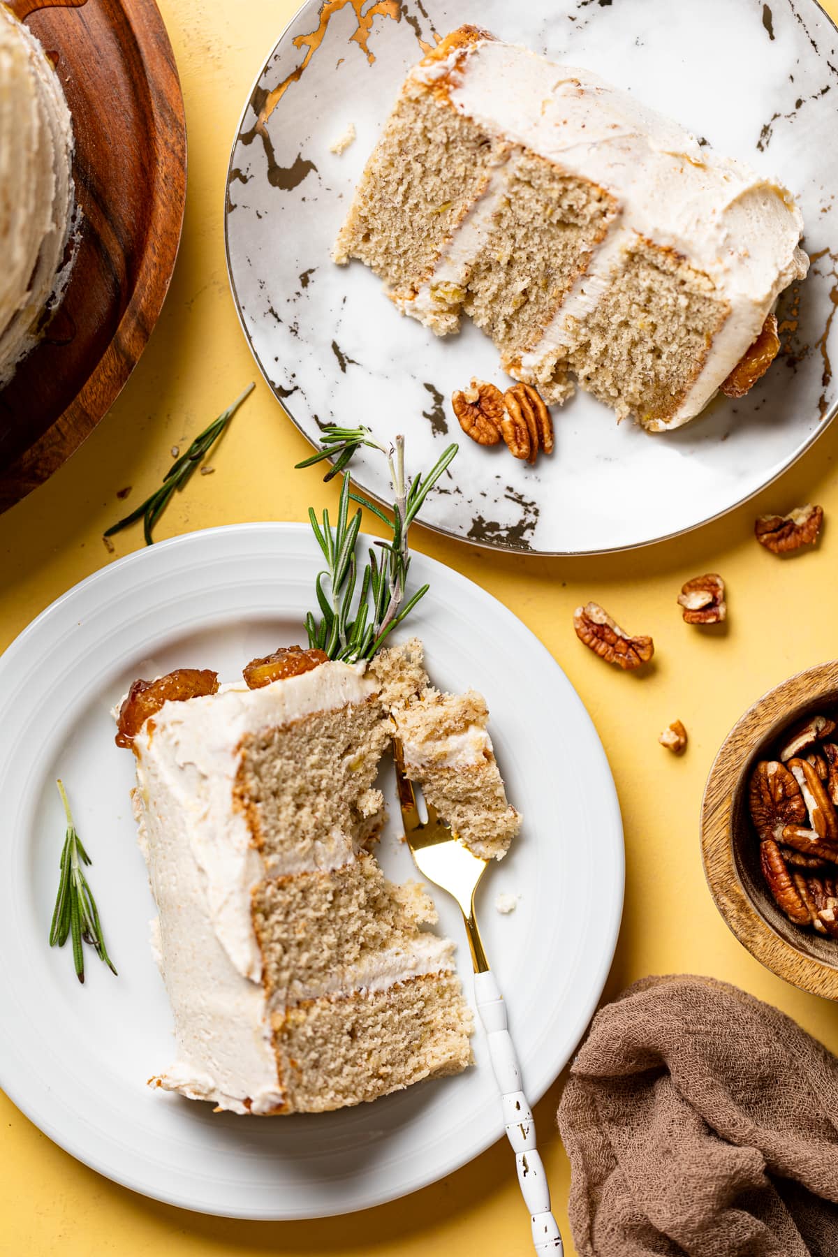 Slices of Vegan Banana Cake with Maple Buttercream lying on a small plates