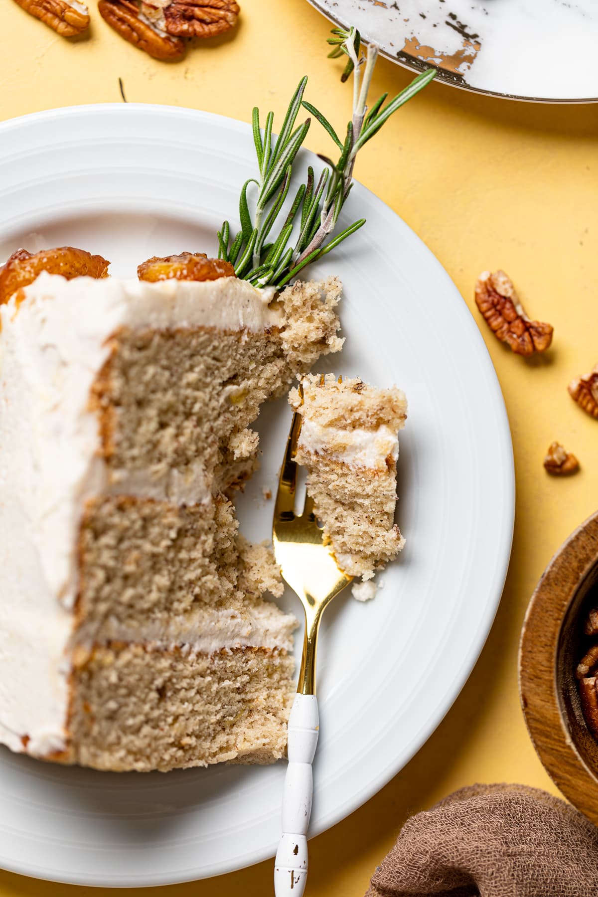 Fork with a piece of a slice of Vegan Banana Cake with Maple Buttercream