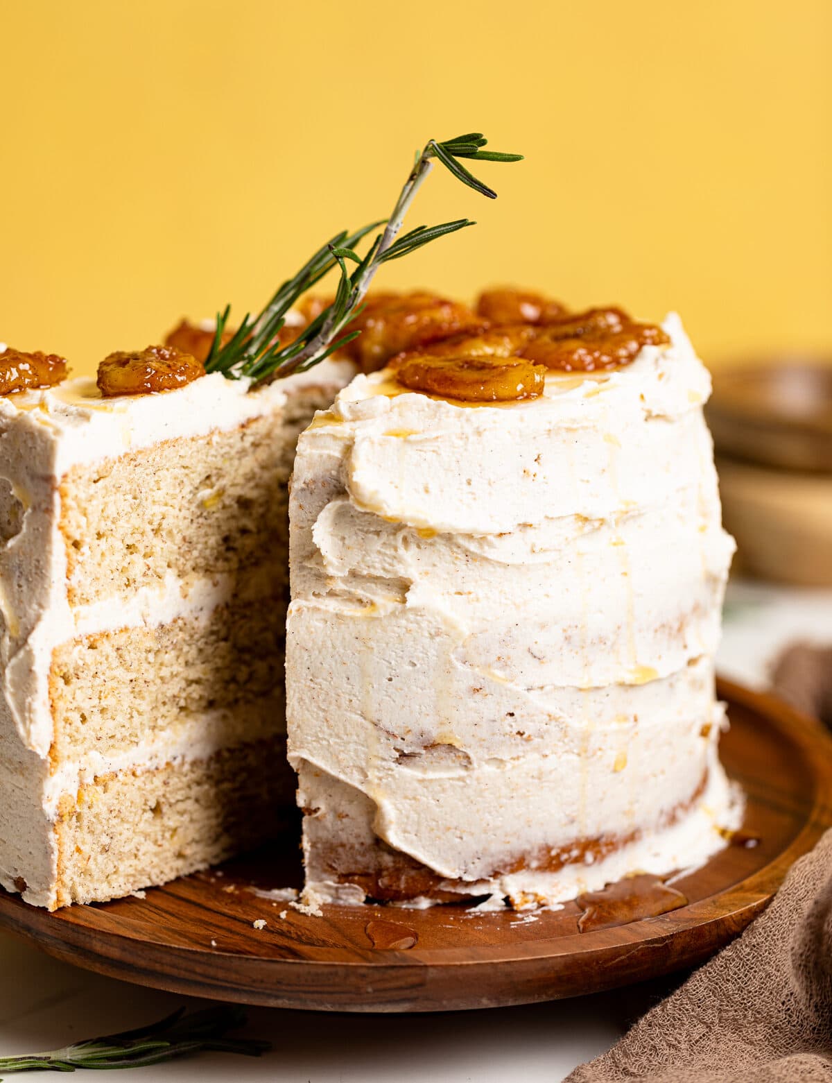 Vegan Banana Cake with Maple Buttercream with a slice pulled out