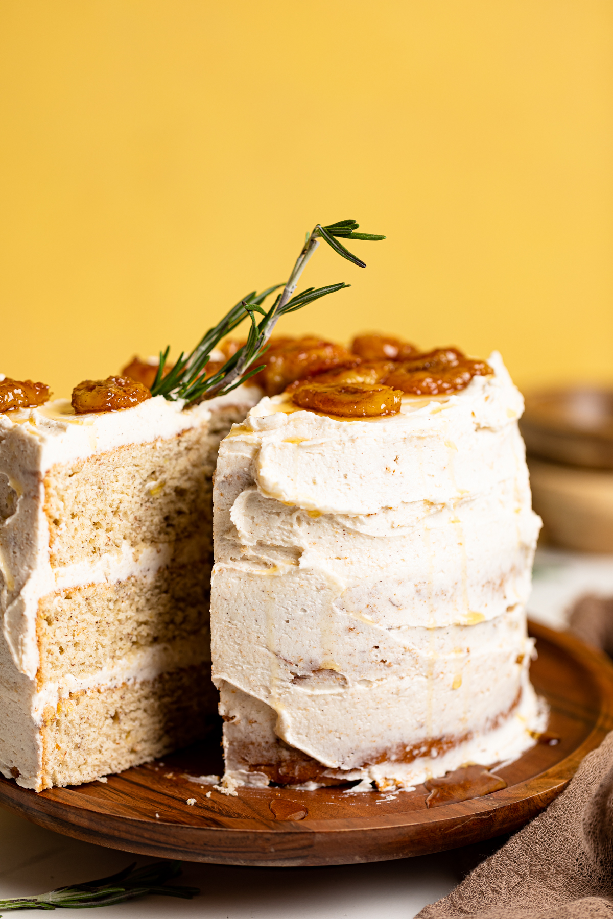 Vegan Banana Cake with Maple Buttercream with a slice pulled out