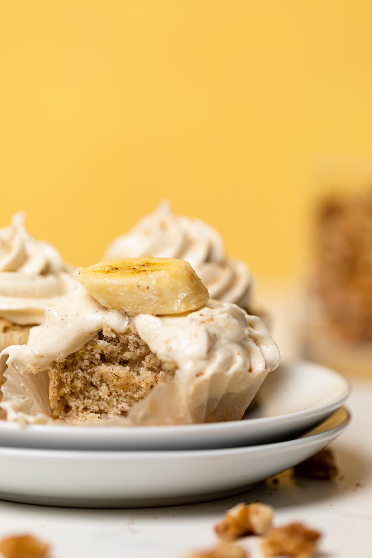 Banana Cupcakes missing a bite and topped with Maple Buttercream.