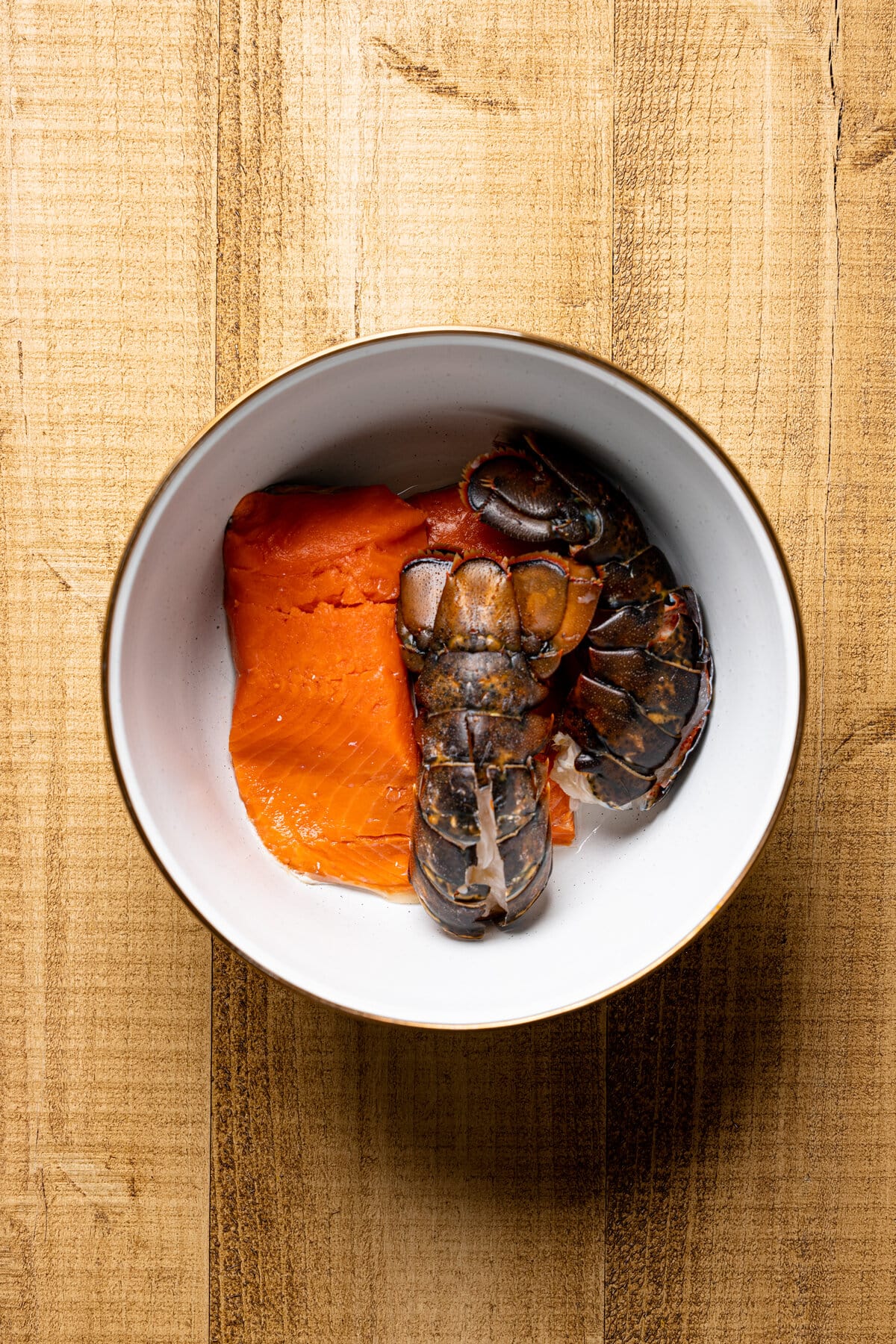 Lobster tails and salmon in a bowl