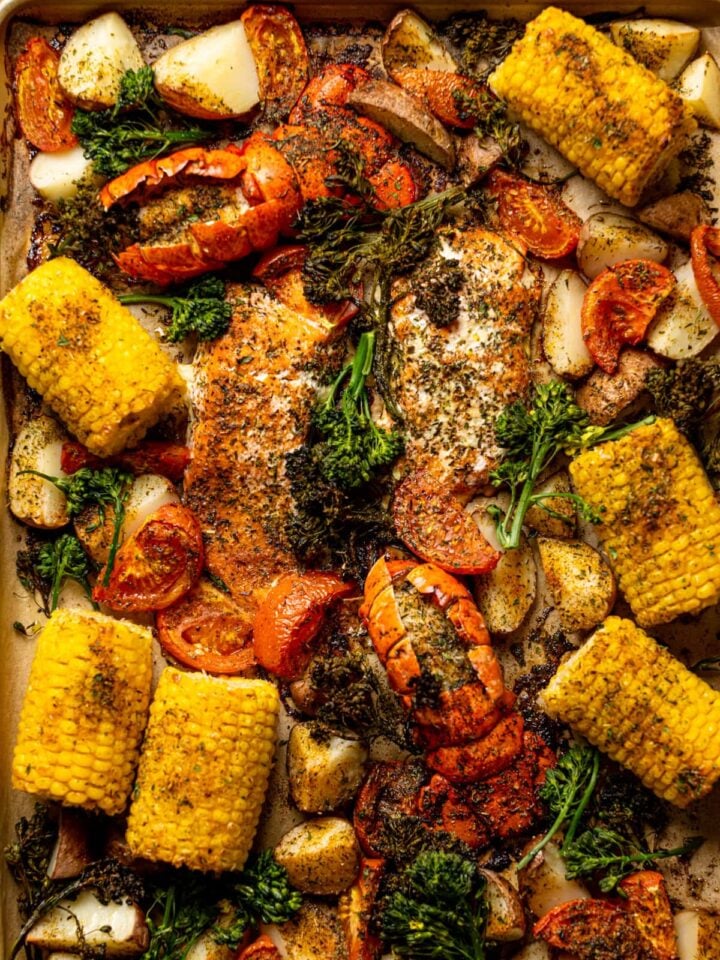 Overhead shot of a Sheet Pan of Garlic Herb Salmon, Lobster, and Veggies