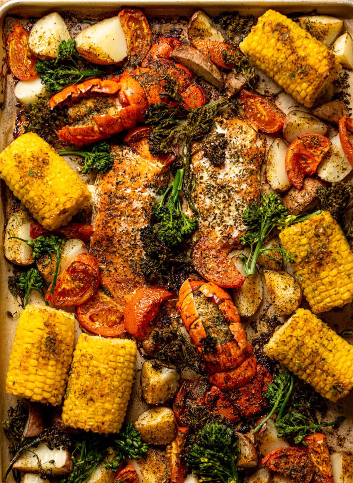 Overhead shot of a Sheet Pan of Garlic Herb Salmon, Lobster, and Veggies