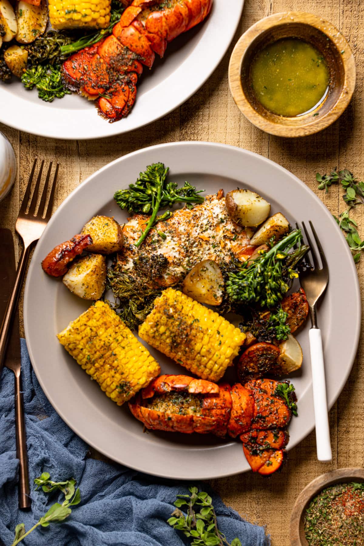 Plate and forks with Garlic Herb Salmon, Lobster, and Veggies