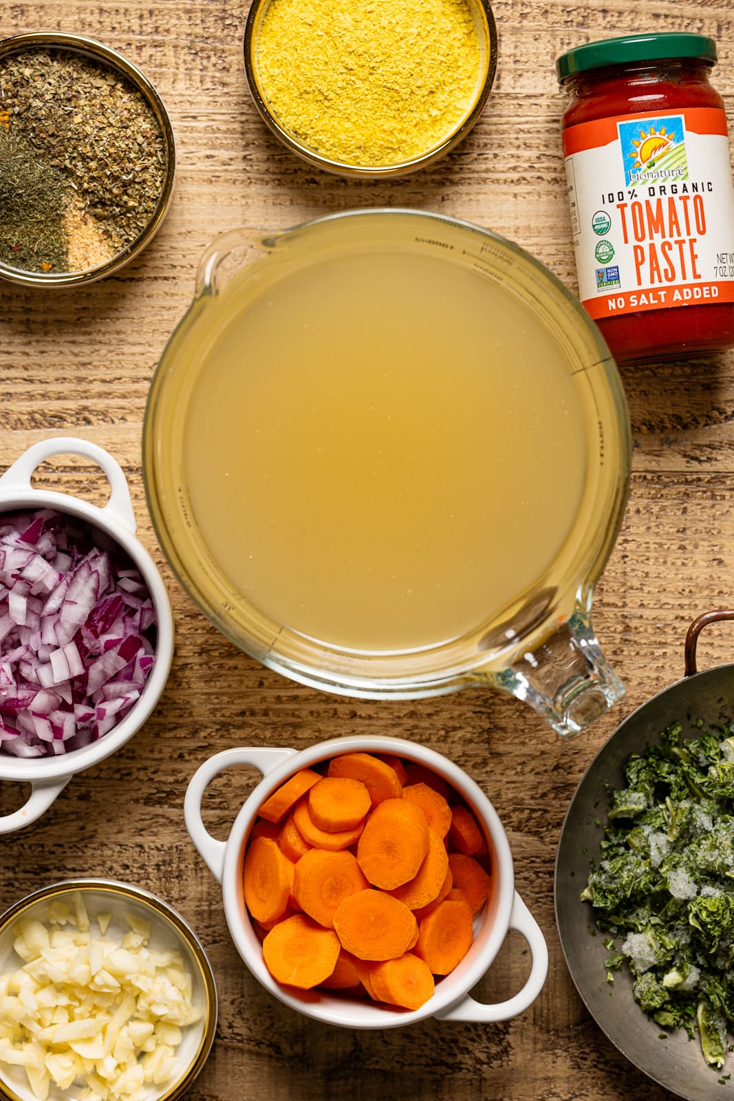 Ingredients including veggie stock, carrots, onions, tomato paste, herbs + seasonings, etc. 