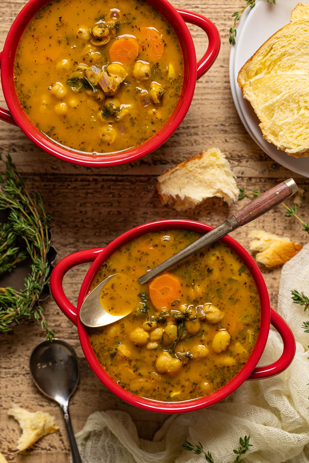 Up close shot of two bowls of soup with a spoon in the bowl.