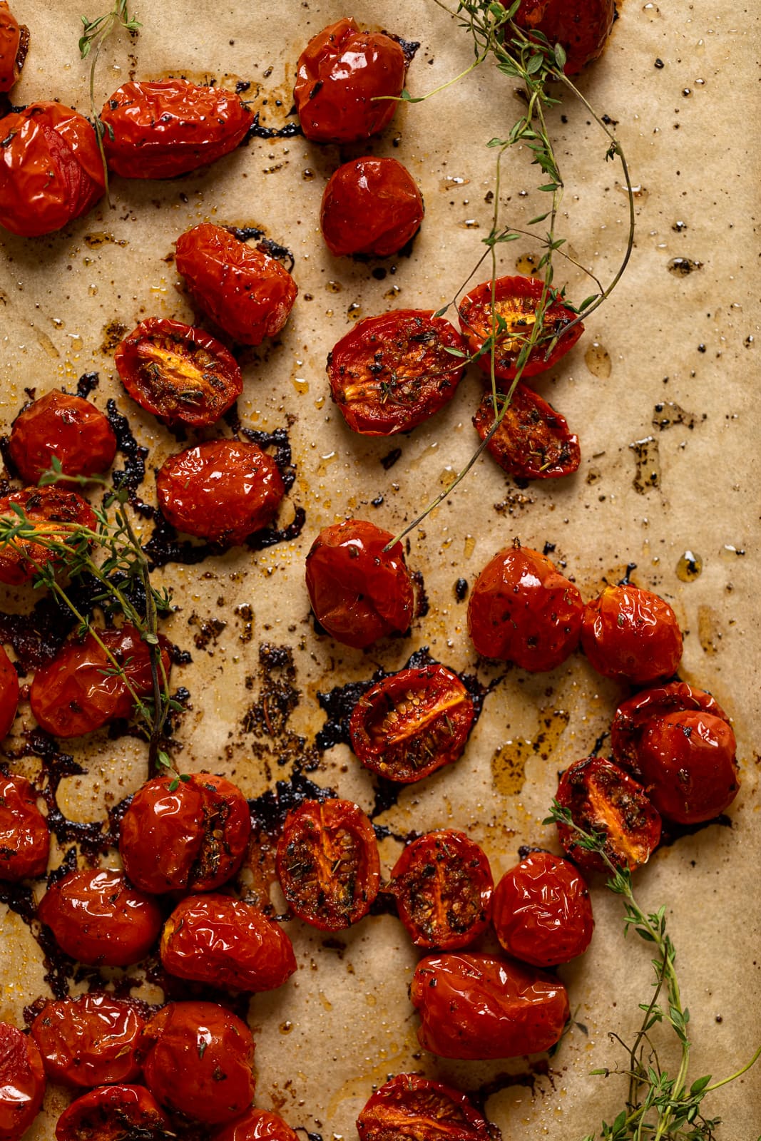Roasted tomatoes and thyme on parchment paper