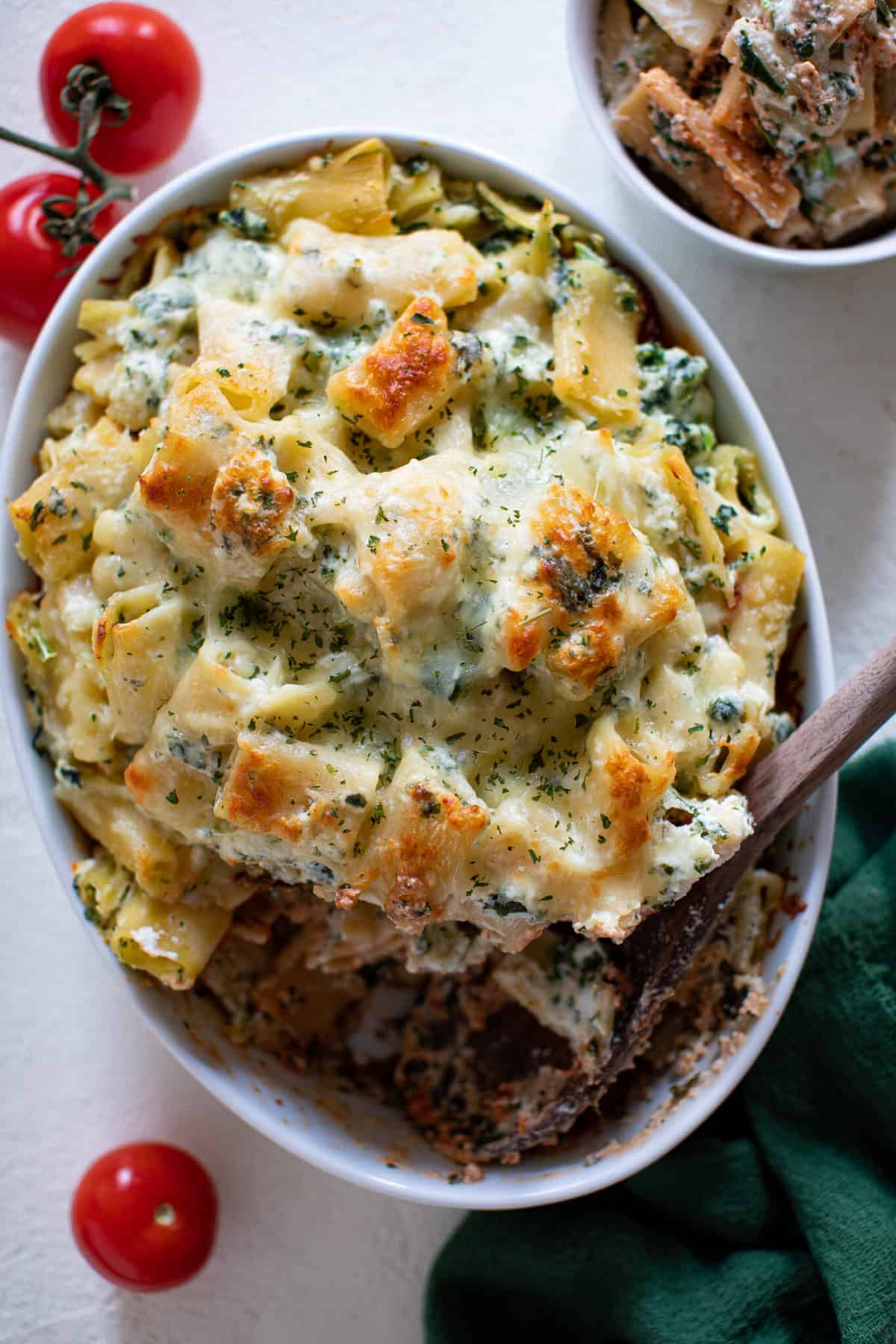 Wooden spoon in a dish of Meatless Baked Ziti with Ricotta and Mozzarella