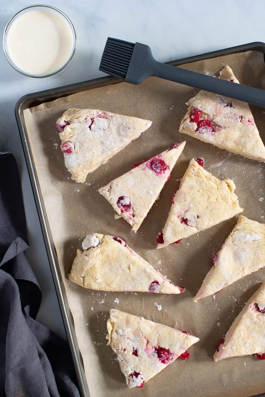 Uncooked Orange Breakfast Scones on baking tray.