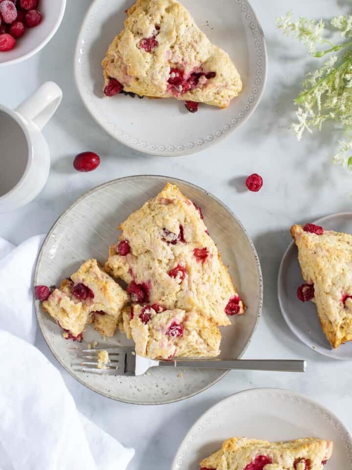 Cranberry Orange Breakfast Scone on a plate with a fork.