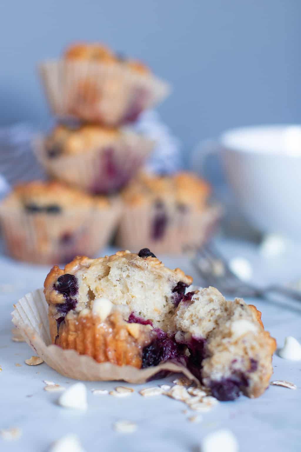 Blueberry Oatmeal White Chocolate Muffin that\'s been pulled apart.