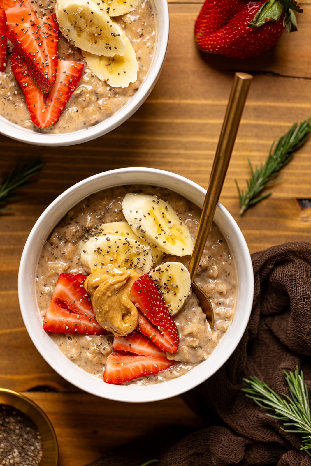 Bowl of oatmeal with two spoons.