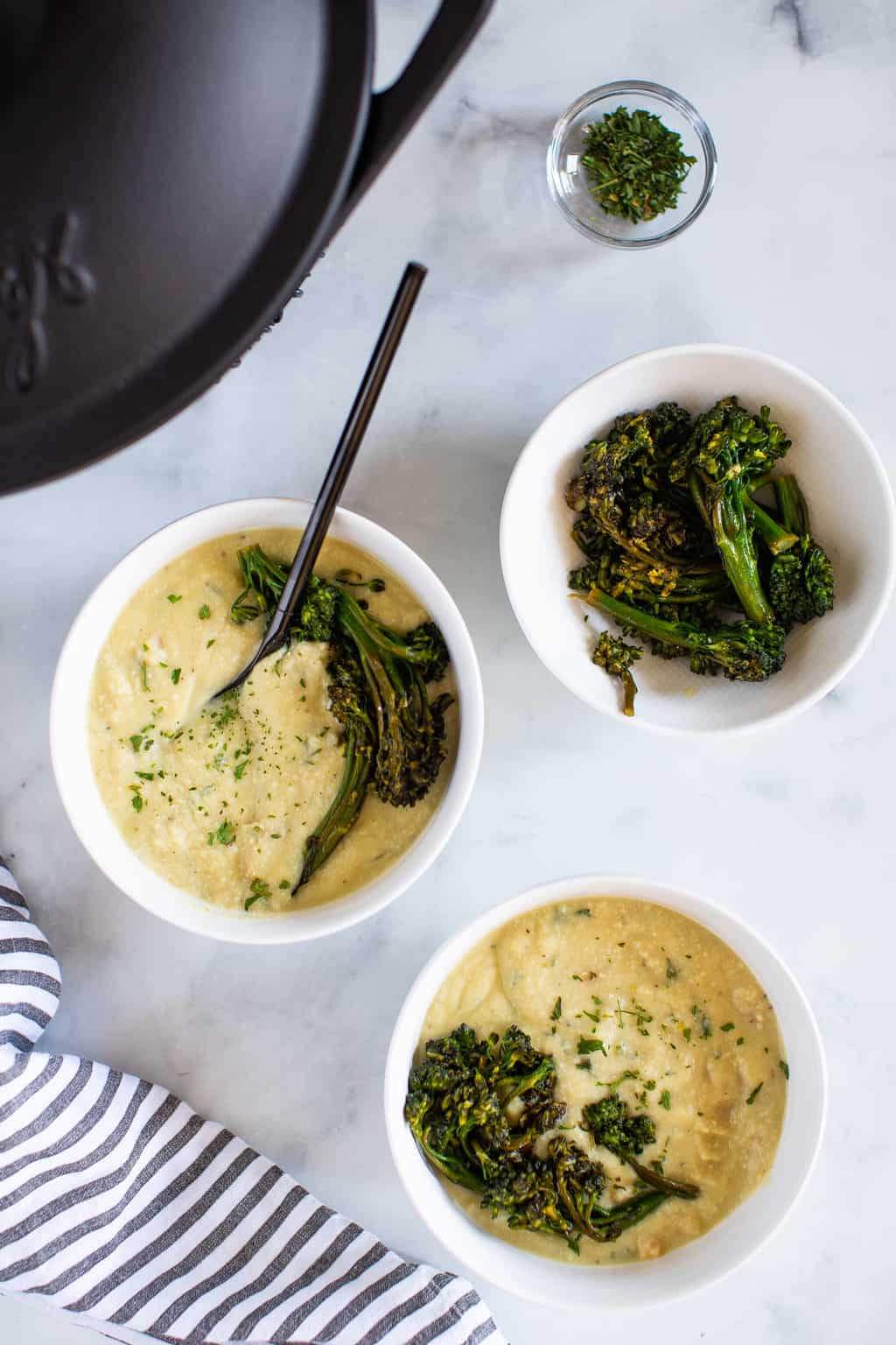 Bowls of Creamy Vegan White Bean Soup with Sautéed Broccolini.