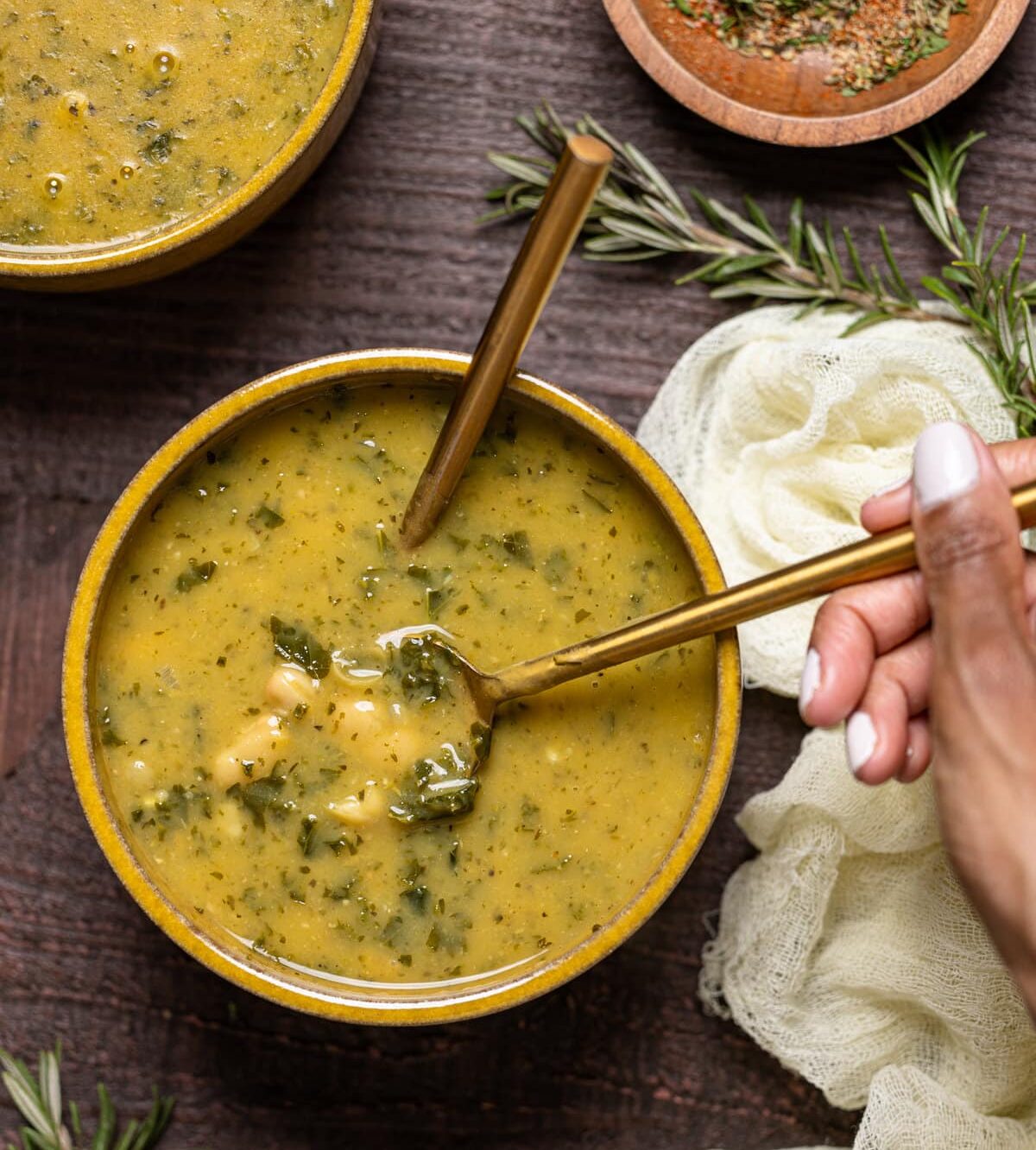 Bowl of Creamy Vegan White Bean Soup with two spoons