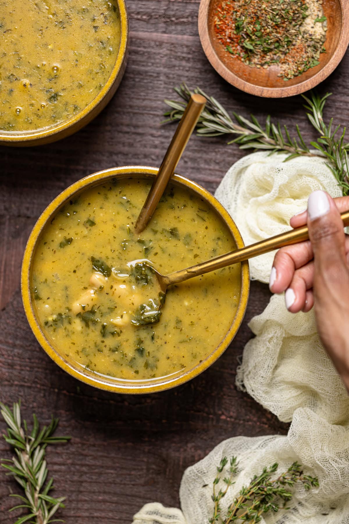 Bowl of Creamy Vegan White Bean Soup with two spoons