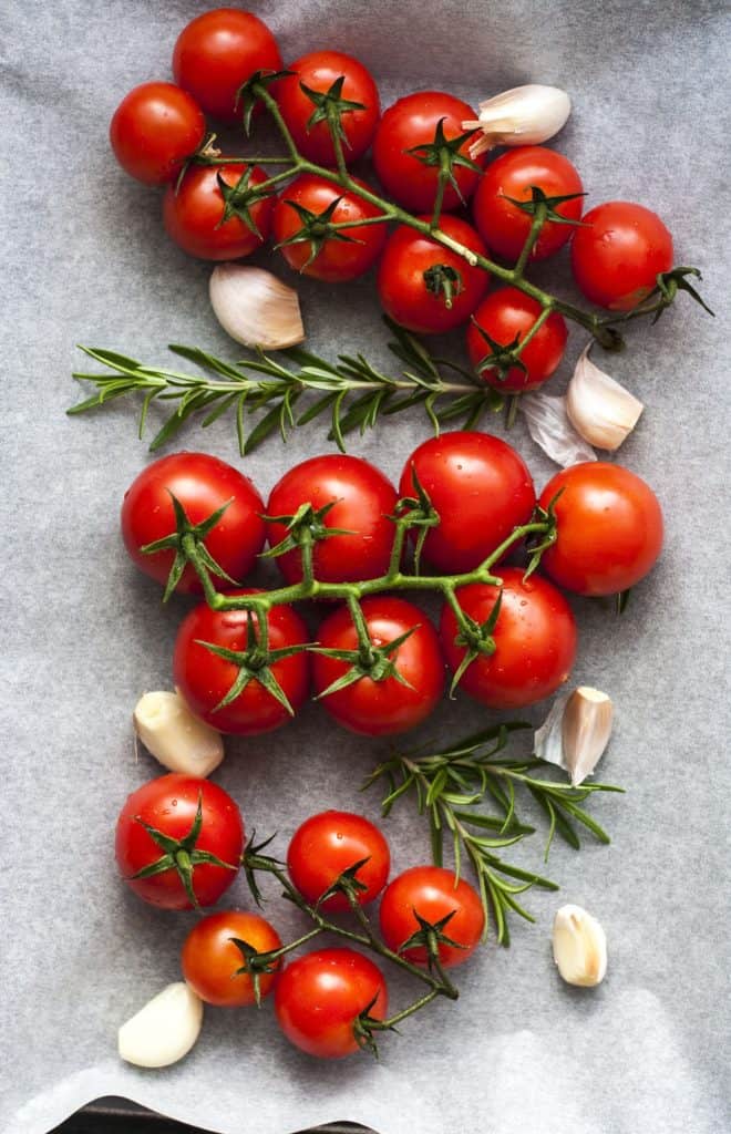 Tomatoes and garlic on a countertop.