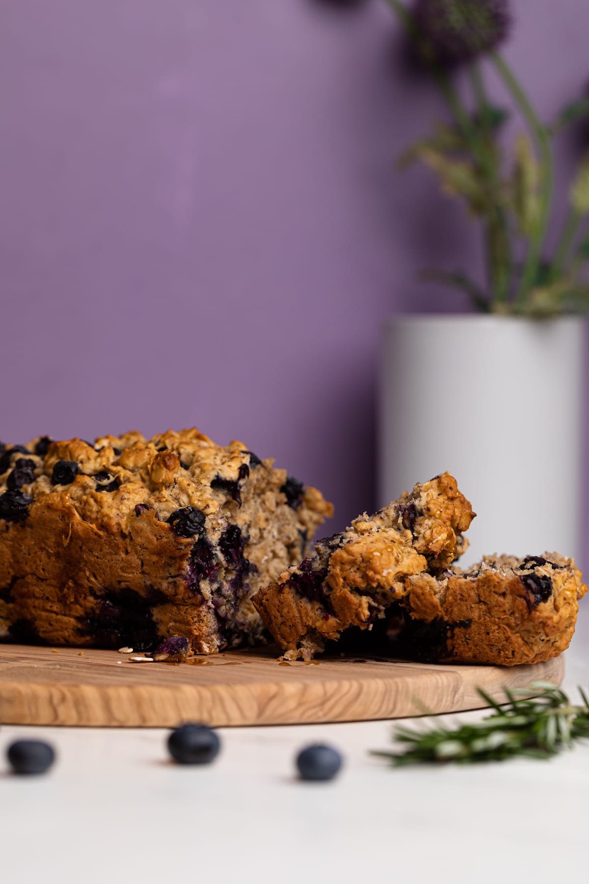 Blueberry Oatmeal Breakfast Bread on a wooden cutting board.