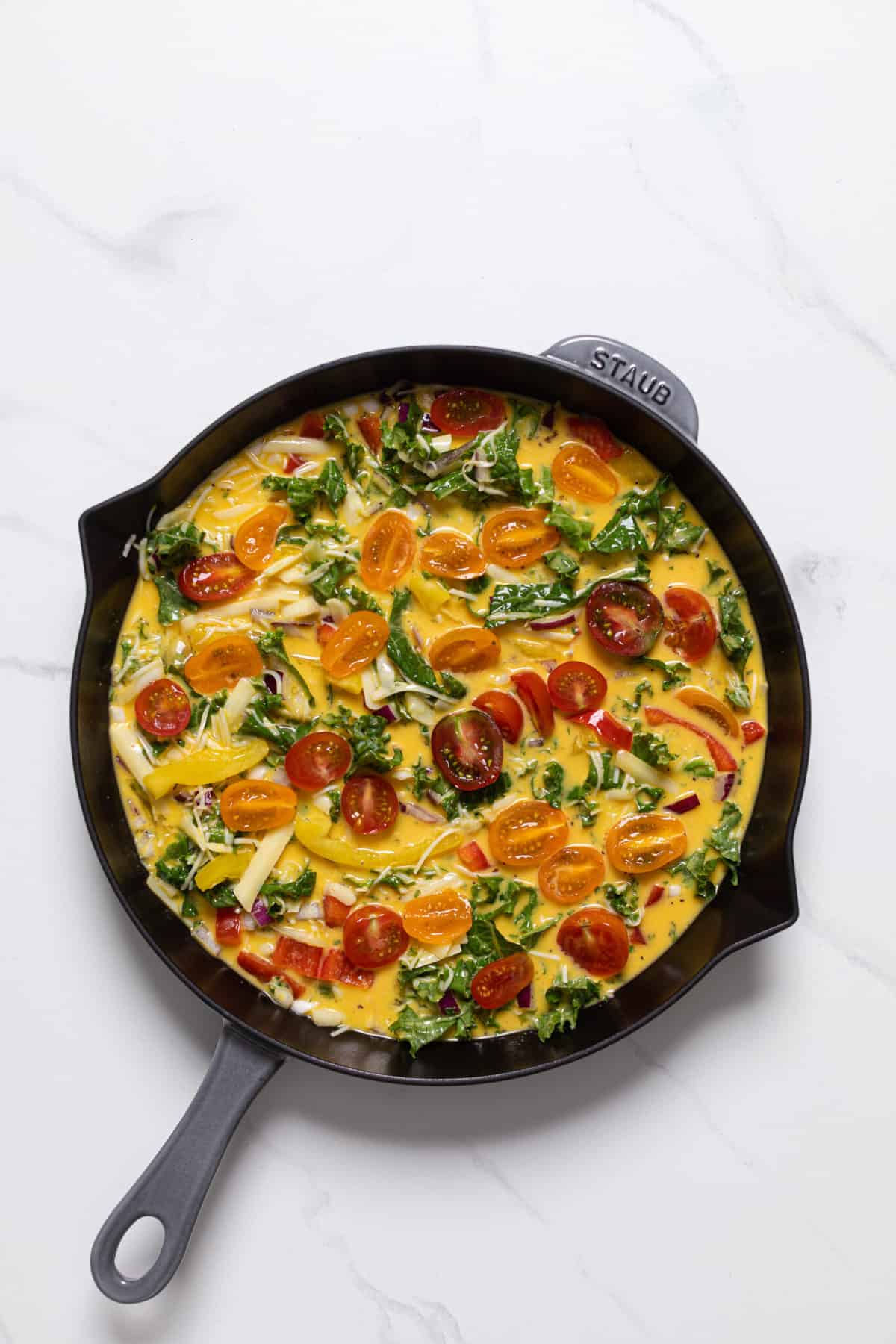 Skillet of uncooked Veggie Frittata.