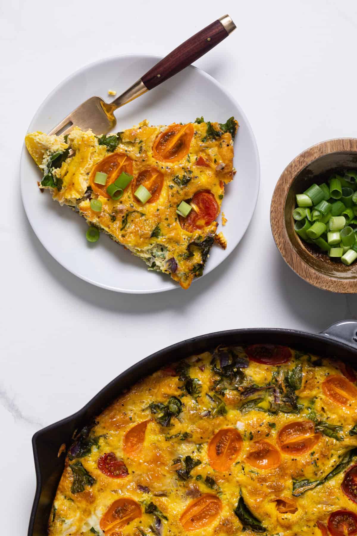 Plate topped with a slice of Veggie Frittata.