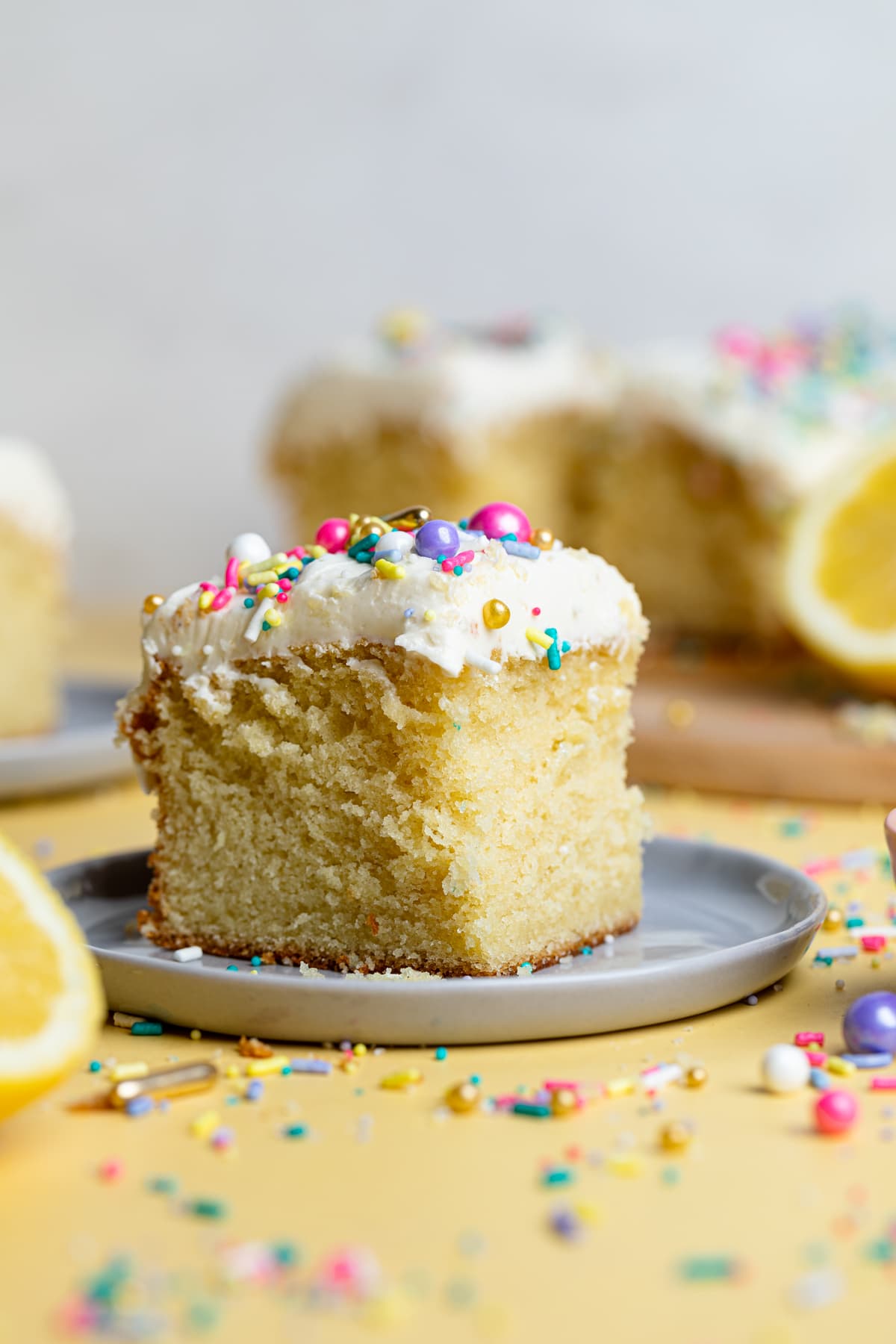 Piece of Lemon Birthday Sheet Cake topped with colorful sprinkles.