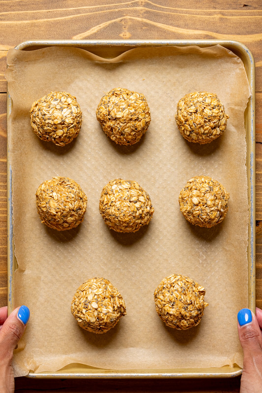 Energy balls rolled and lined on a baking sheet with parchment paper. 