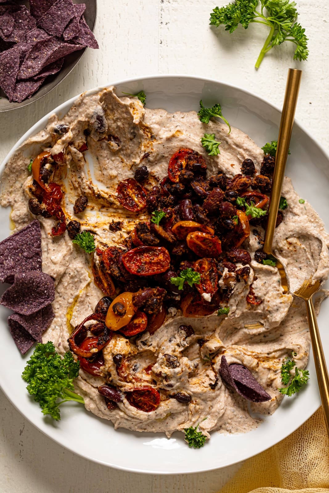 Garlic Herb Three Bean Dip with several scoops missing