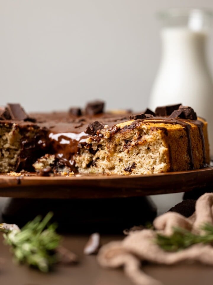 Vegan Chocolate Chip Banana Cake on a raised wooden platter.