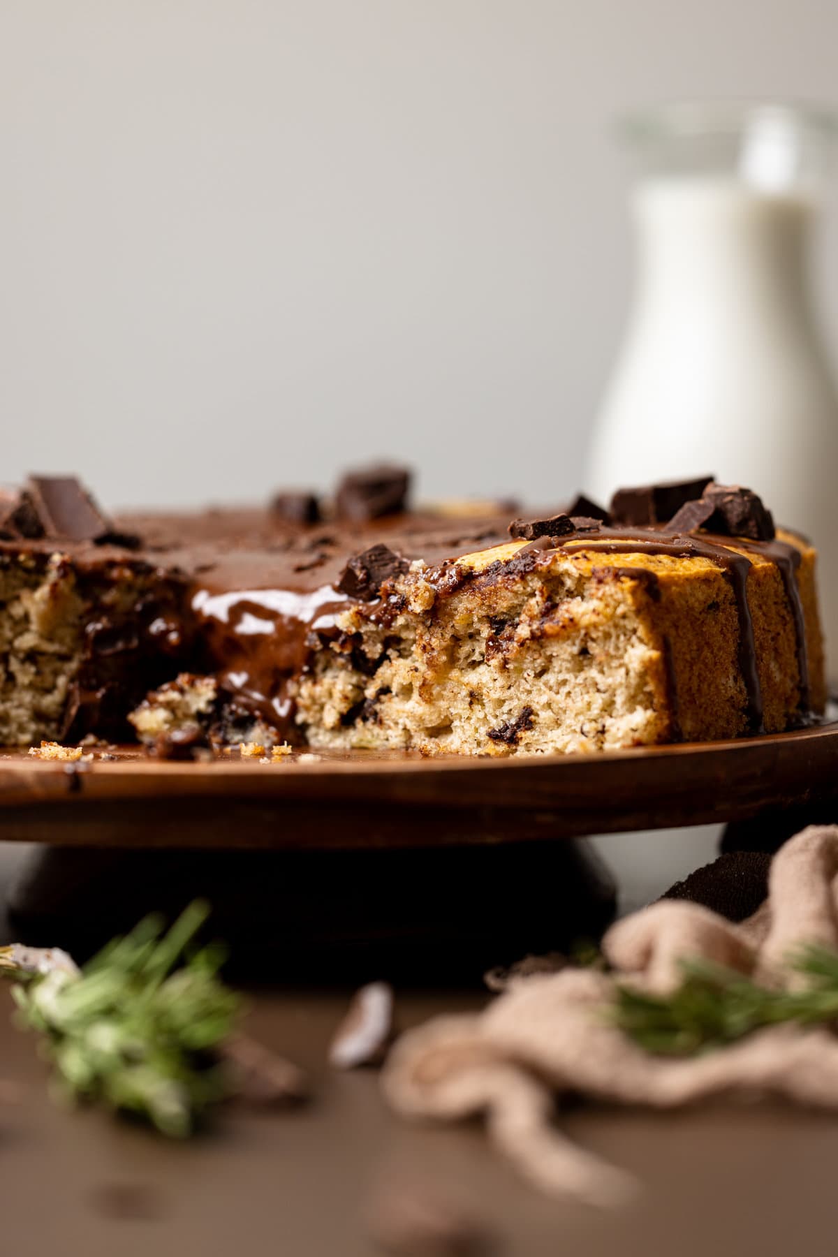 Vegan Chocolate Chip Banana Cake on a raised wooden platter.