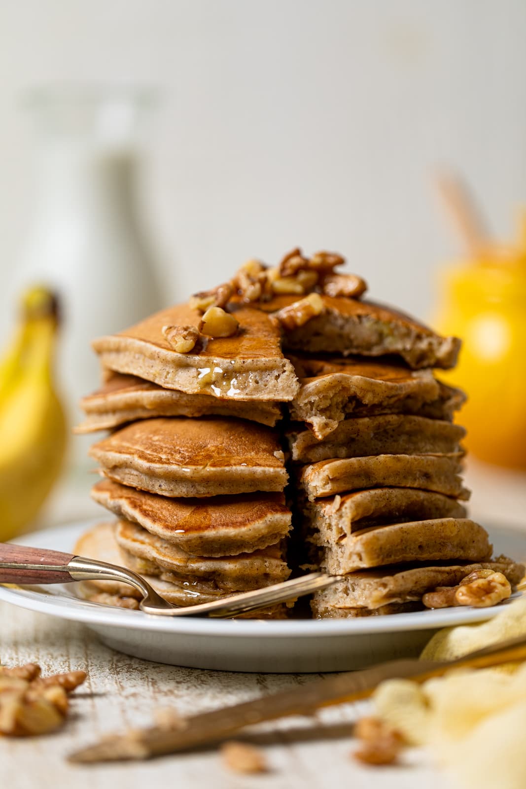 Stack of Healthy Banana Bread Pancakes with slices cut out and a fork