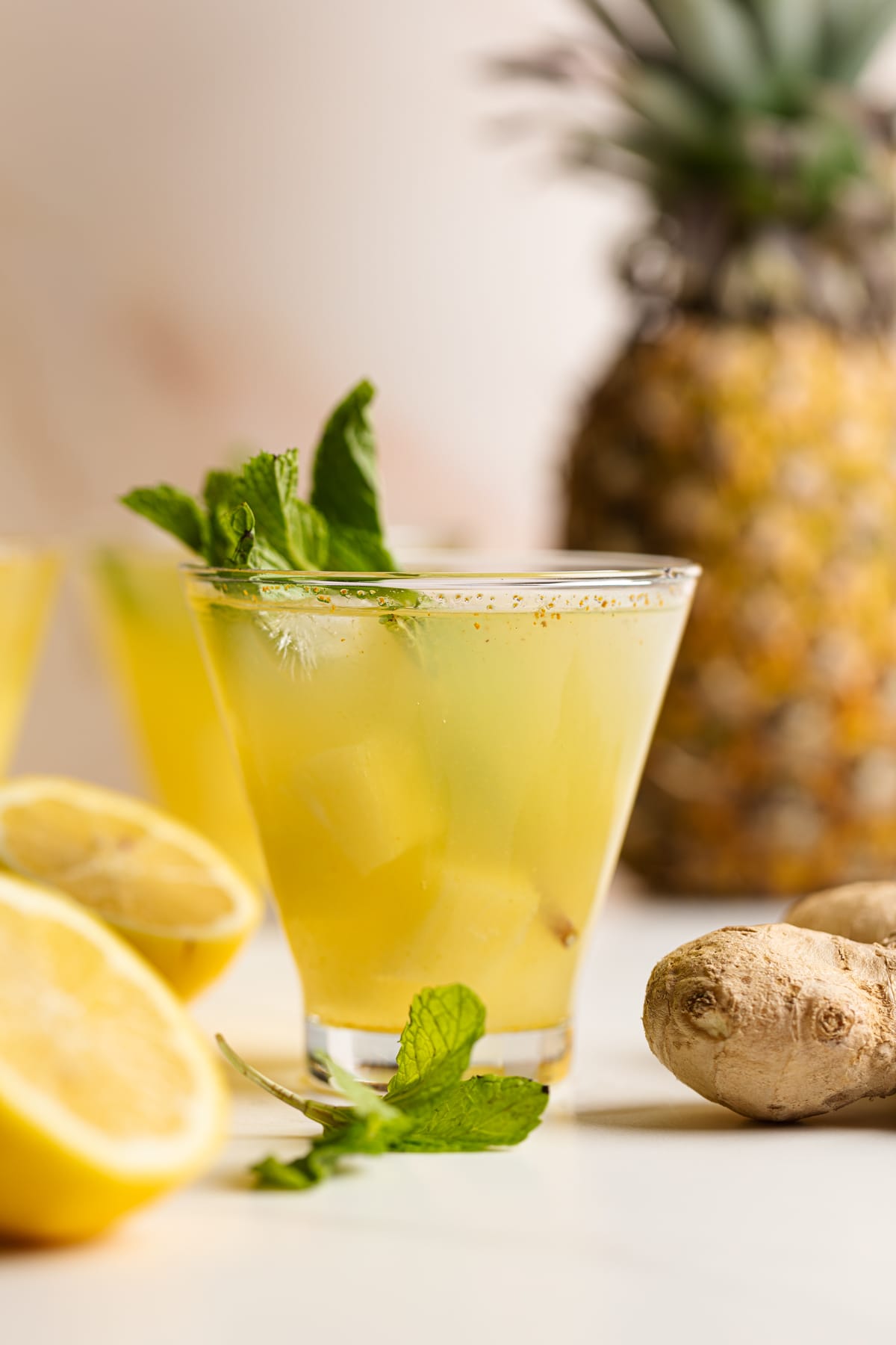 Small glass of Pineapple Ginger Turmeric Lemonade.