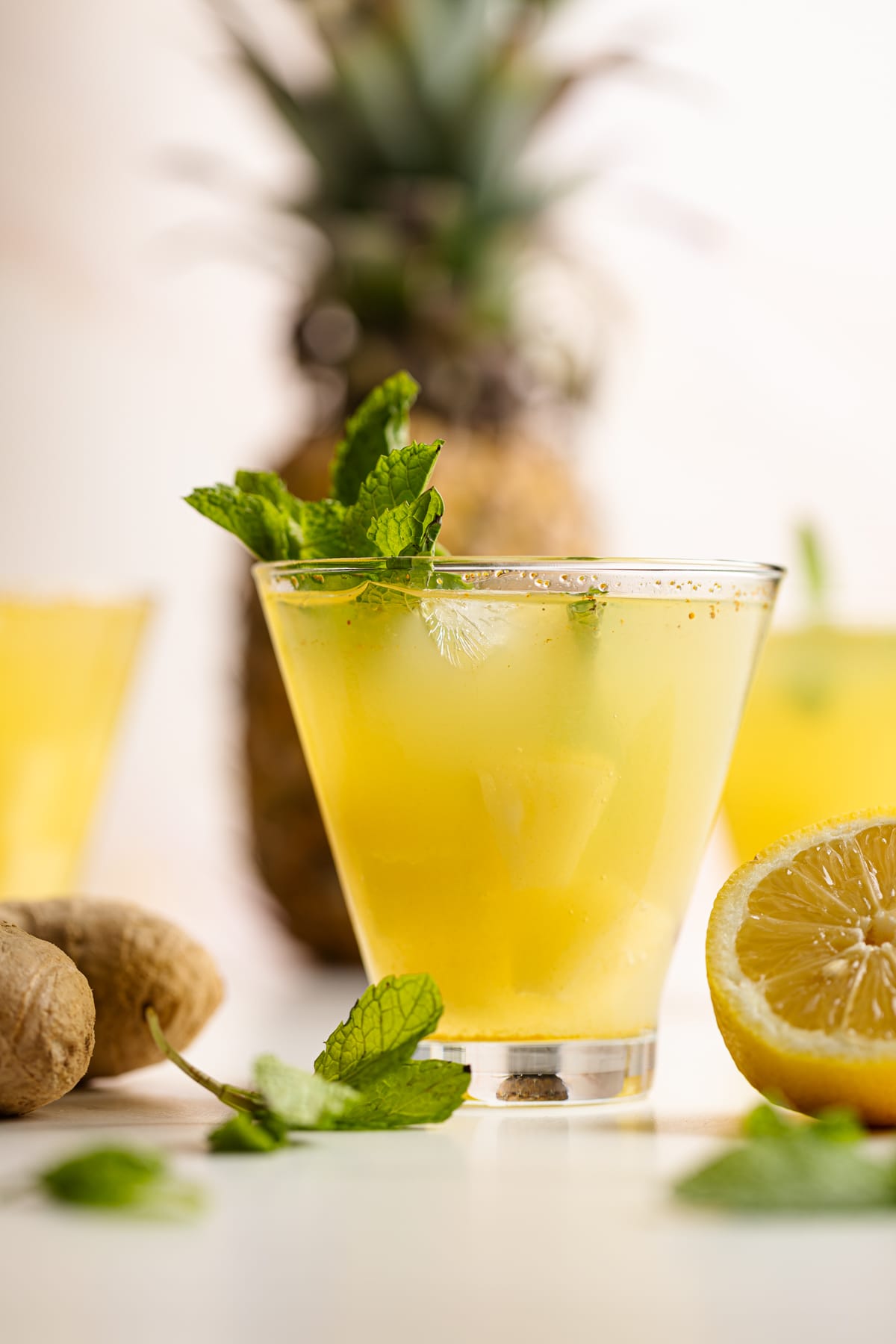 Pineapple Ginger Turmeric Lemonade garnished with mint leaves.