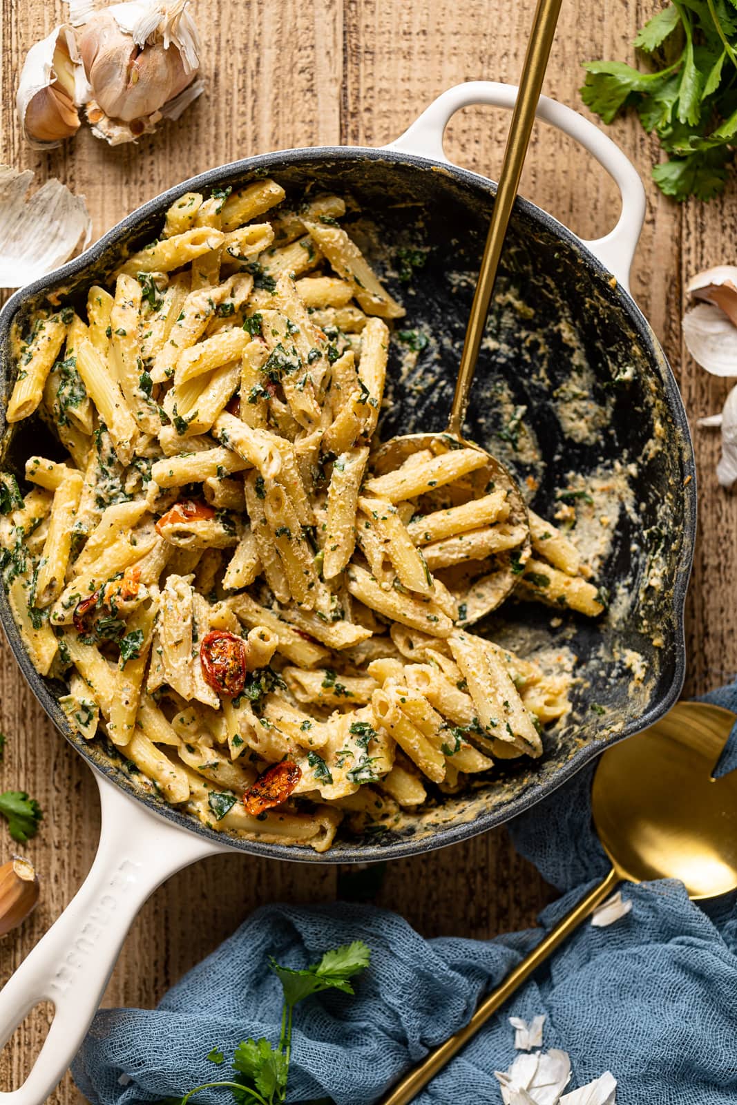 Half-served skillet of Creamy Vegan Tuscan Kale Pasta