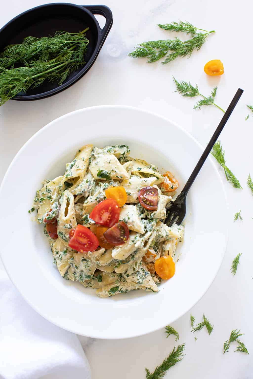 Fork in a bowl of Creamy Vegan Tuscan Kale Pasta.