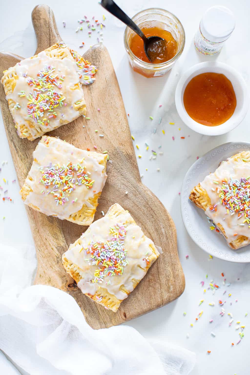 Vegan Apricot Pop Tarts on a board and a plate.