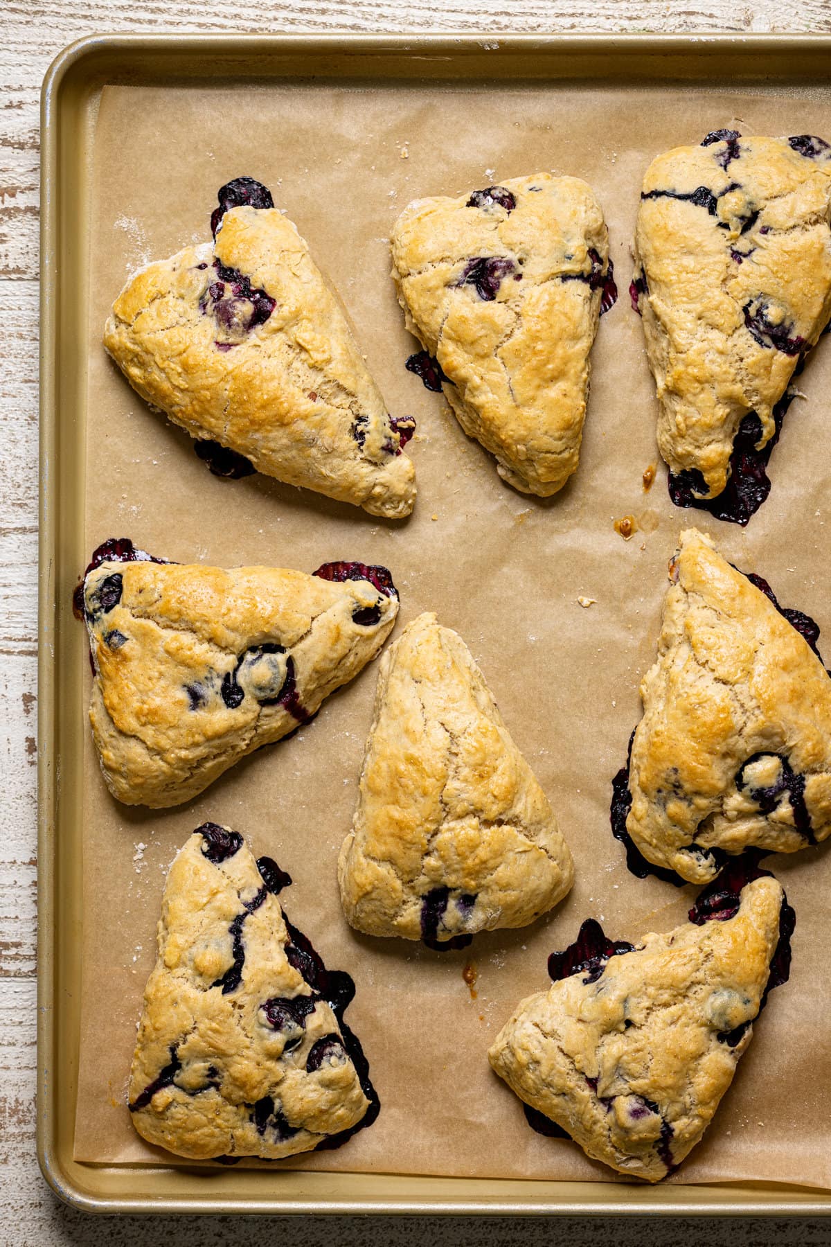 Dairy-Free Blueberry Almond Scones on a lined baking sheet.