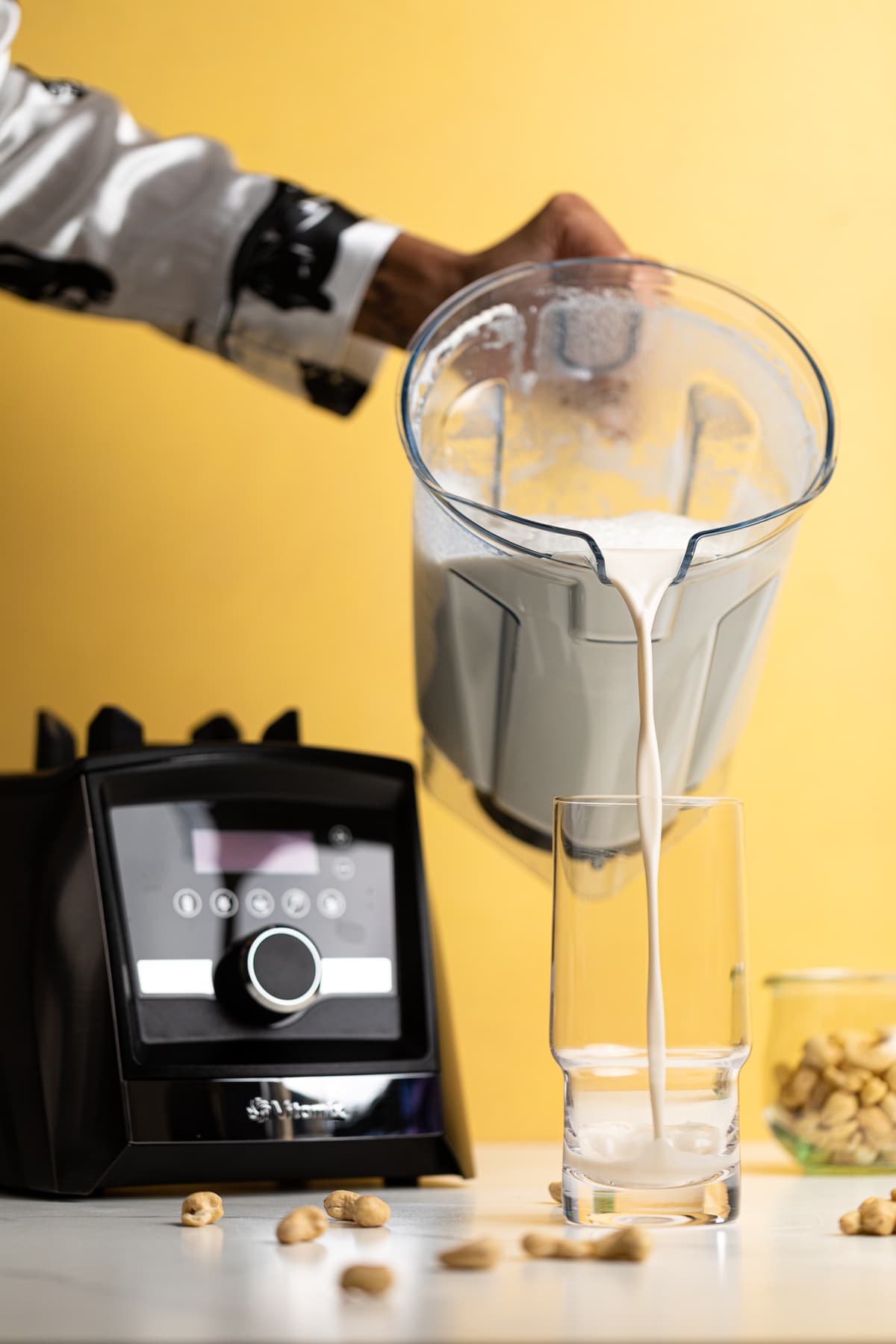 Blender pouring Creamy Cashew Milk into a glass