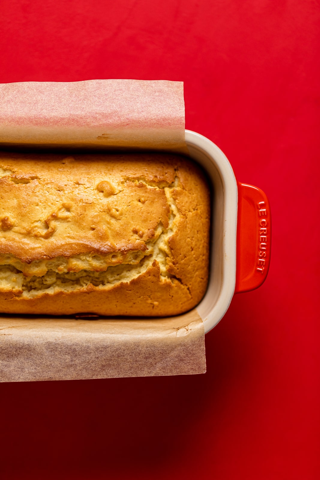 Cream Cheese Pound Cake in a red Le Creuset bread pan.