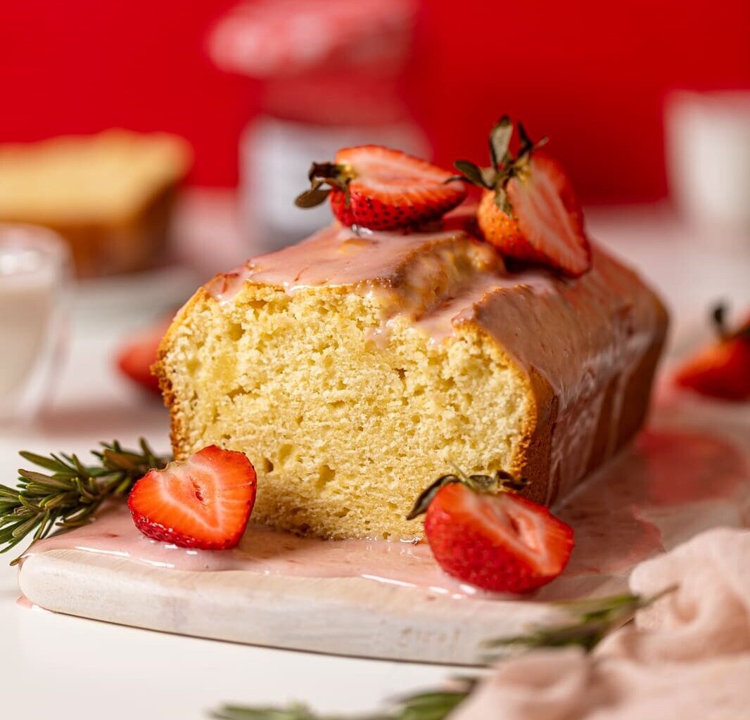 Cream Cheese Pound Cake with Strawberry Glaze on a serving board.