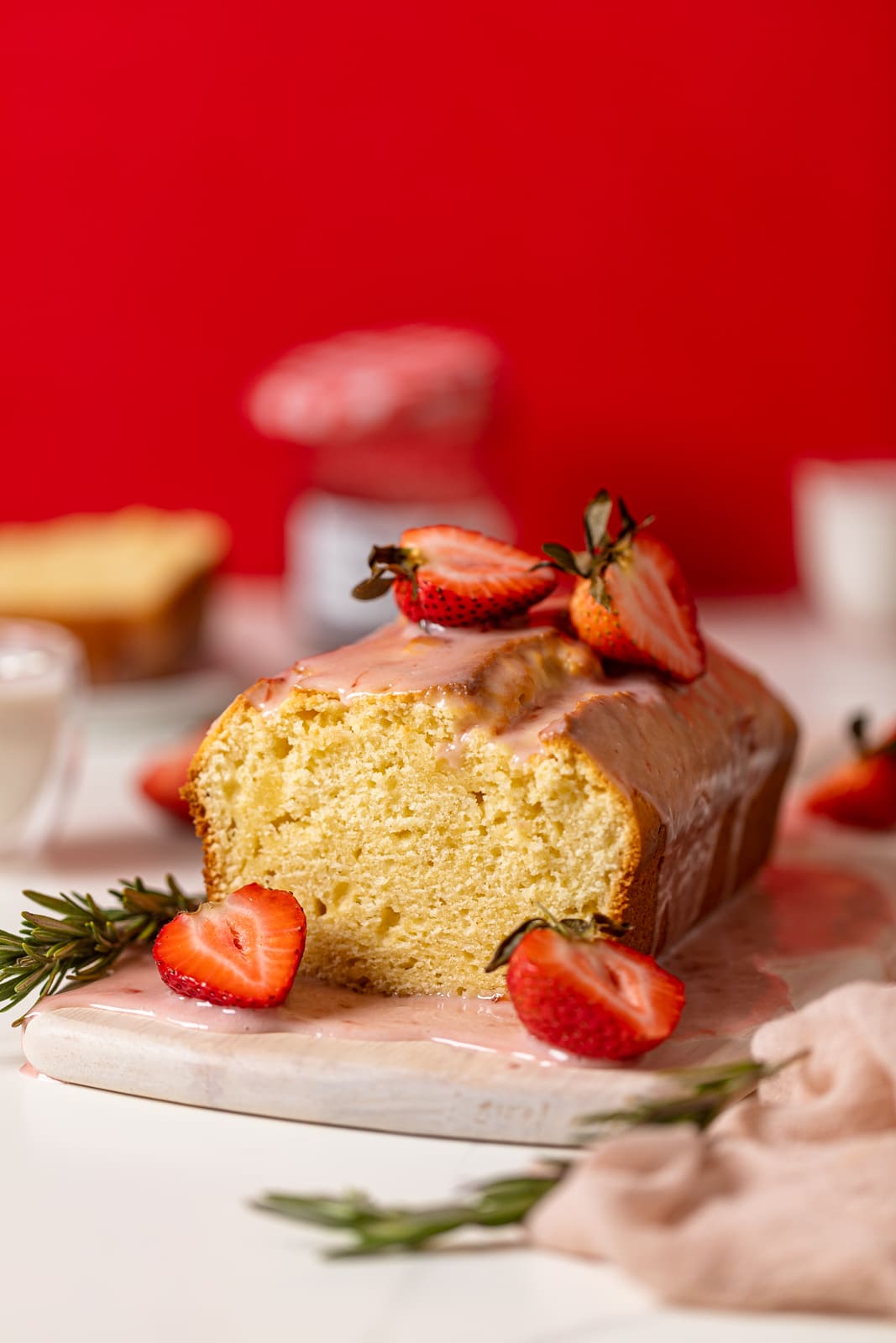 Cream Cheese Pound Cake with Strawberry Glaze on a serving board.