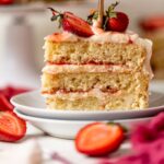 Slice of Strawberry Shortcake Birthday Cake on two small, stacked plates.
