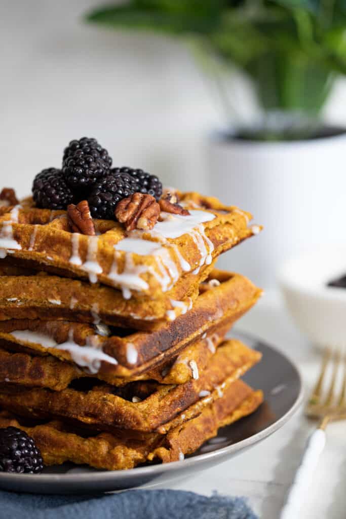 Flourless Vegan Sweet Potato Oats Waffles topped with blackberries and nuts.