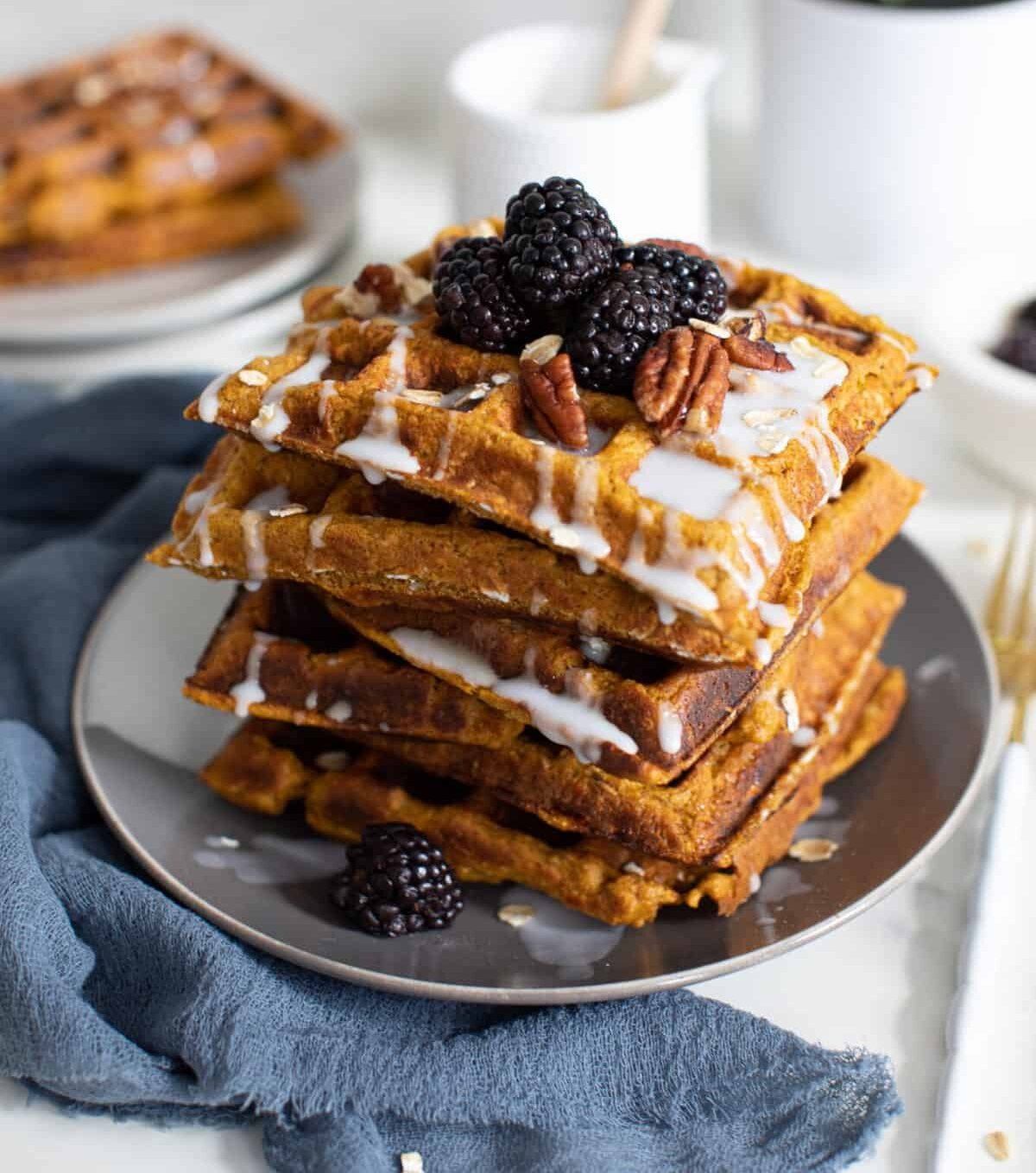 Flourless Vegan Sweet Potato Oats Waffles topped with blackberries and nuts.