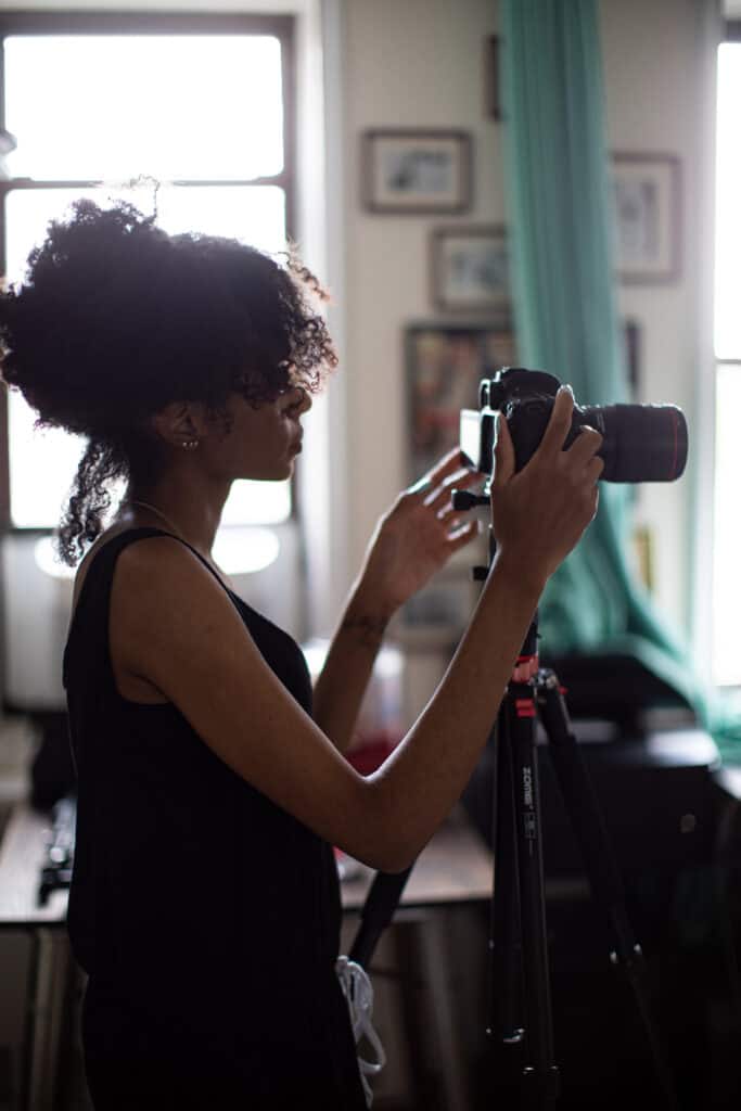 Shanika adjusting a camera.