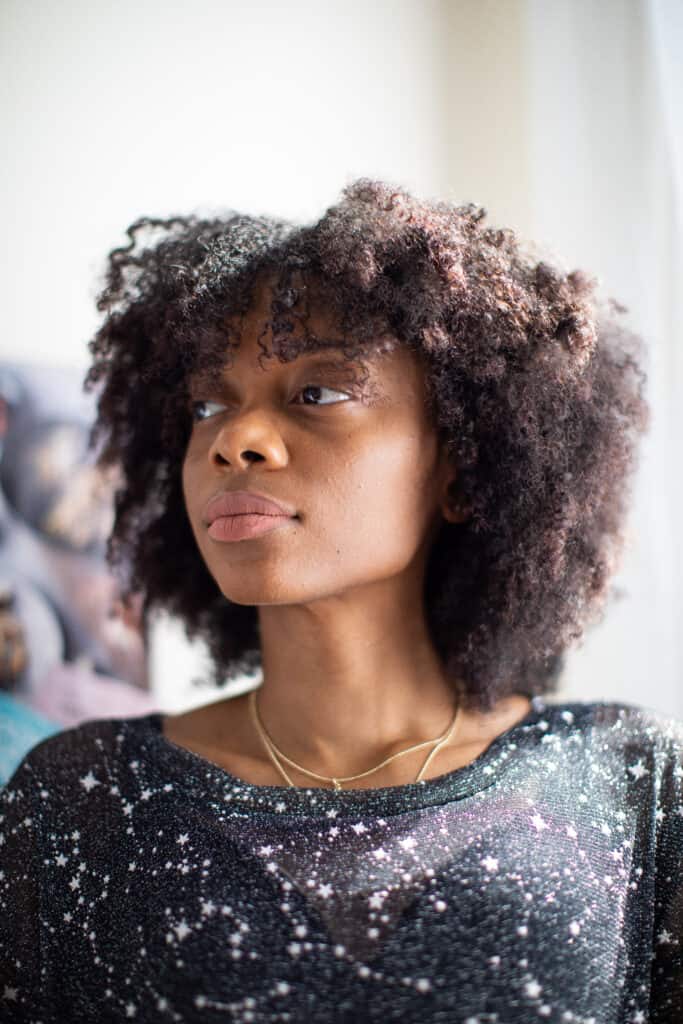 Shanika wearing a black, starry shirt.